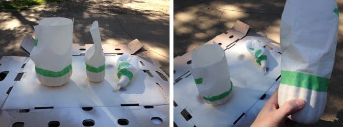 Three fake gourds and pumpkins masked off with painters tape and paper towels.