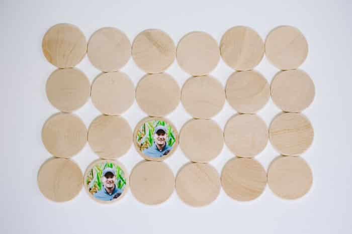 A DIY memory match game made with wooden circle discs and photos attached with Mod Podge.