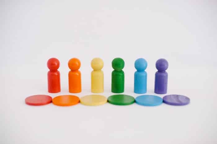 Wooden peg people painted rainbow colors