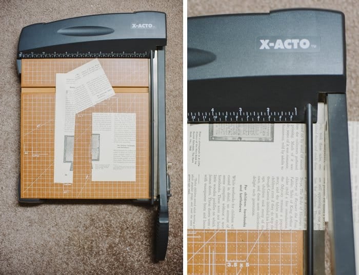 Cutting old book pages into rectangles on a paper cutter.
