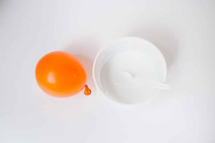 An inflated balloon and diluted glue mixture, ready to make a yarn balloon ball.
