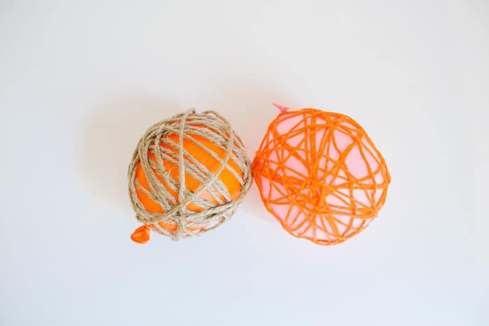 Yarn wrapped around balloons, waiting for the glue mixture that coats the yarn to dry.