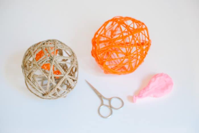 Yarn balls with the balloons inside popped by small scissors.
