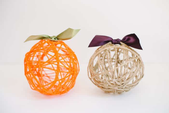 Yarn balls with ribbons tied on top to make yarn ball pumpkins for fall.