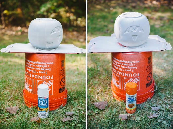 Plastic Halloween treat buckets being spray painted outside.