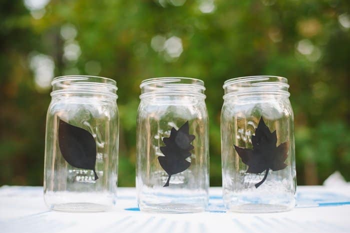 Vinyl leaf decals on mason jars for an easy fall decoration idea