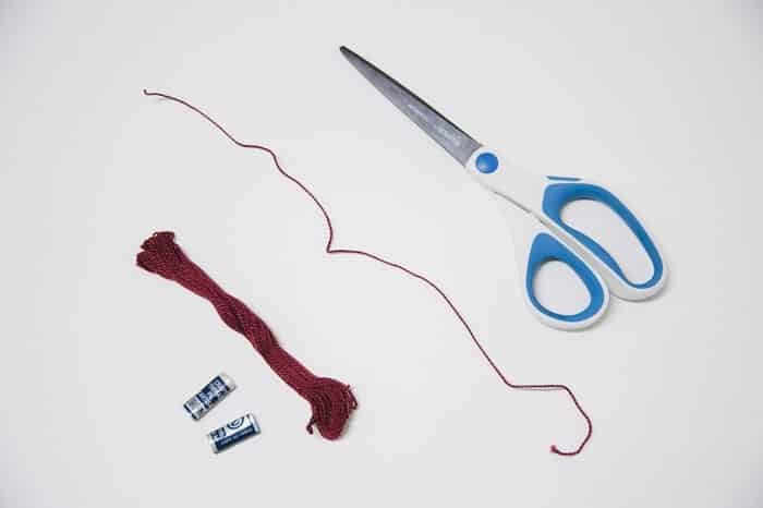 Cut embroidery floss with a scissors