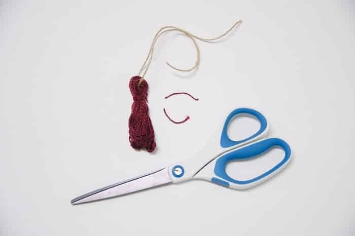 use scissors to trim tassel