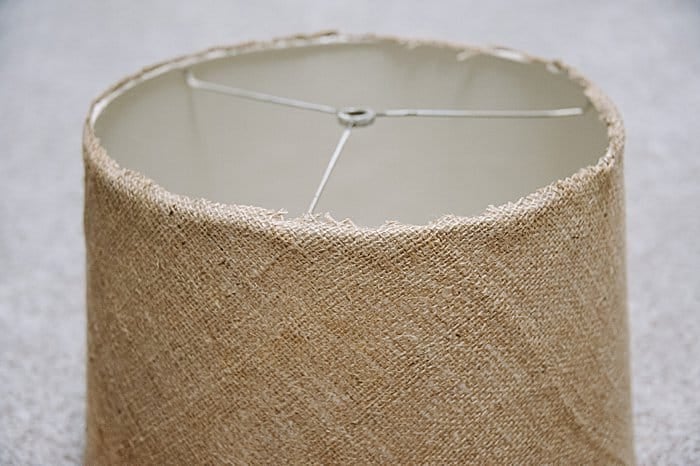 Hot glue edges of burlap down onto lampshade