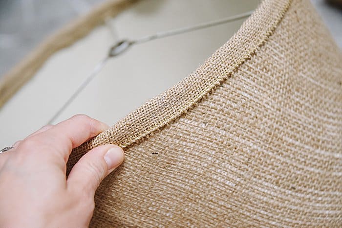 burlap ribbon and hot glue finishes off a DIY burlap lamp shade