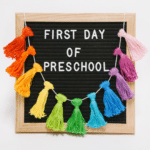 A Showstopper_ First Day of School Sign with a Rainbow Tassel Garland