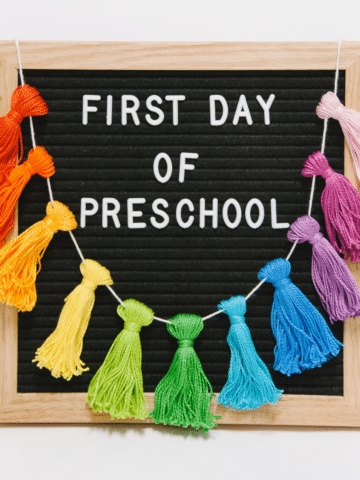 A Showstopper_ First Day of School Sign with a Rainbow Tassel Garland
