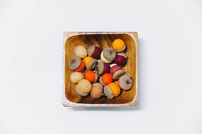 felt acorns can be displayed in a wooden bowl or other decorative dish