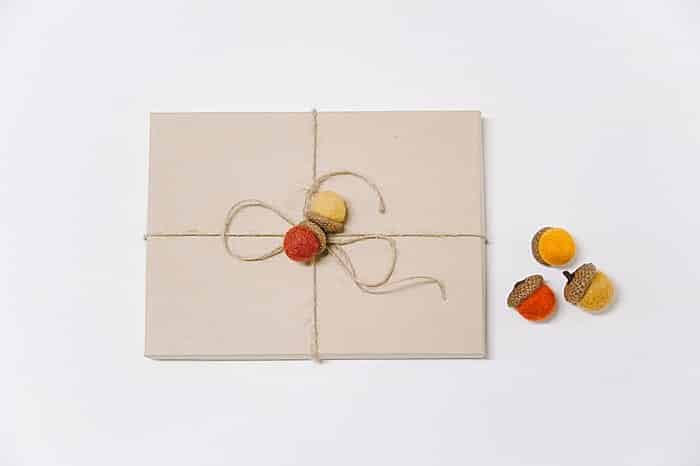 use felt ball acorns as decorative gift wrap embellishments