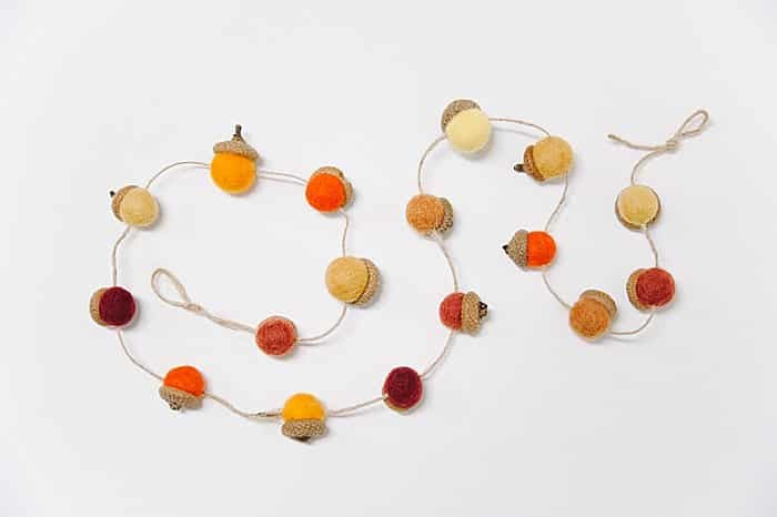 String felt acorns onto twine for a DIY fall garland