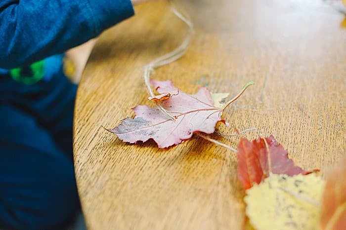 string leaves onto twine for an easy fall leaf garland