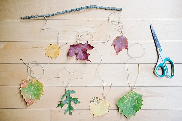 tie each piece of twine to the stick in the desired order for your fall wall hanging