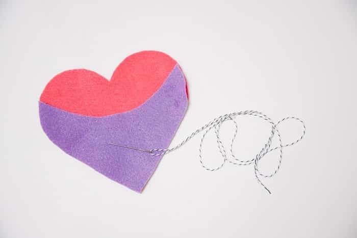Felt hearts and a needle and baker's twine.