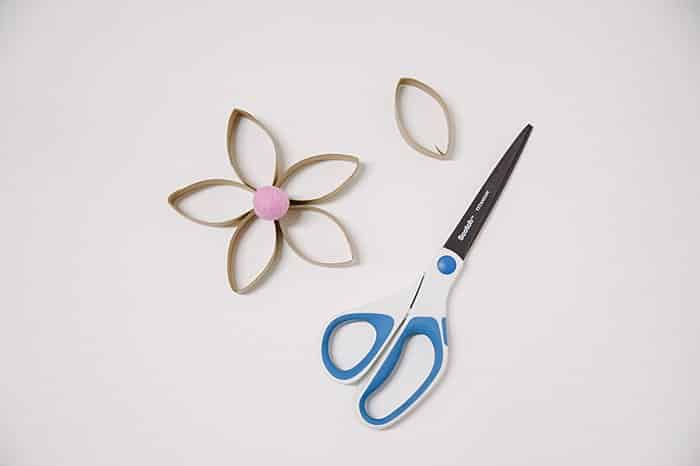 A diy toilet paper roll flower with a felt ball center.