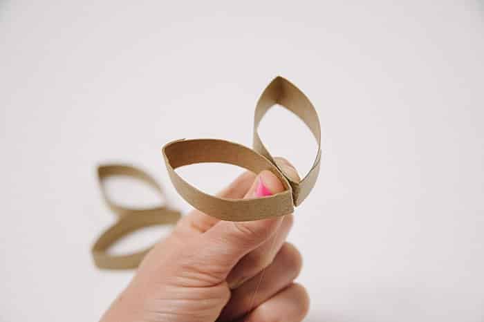 Toilet paper roll pieces being hot glued together.