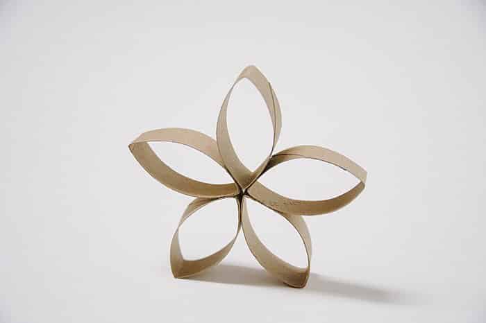 A petal flower made out of a cardboard toilet paper tube.