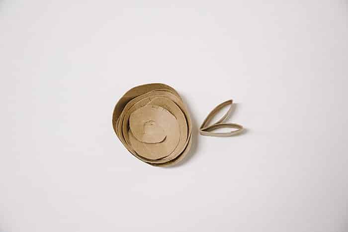 A diy paper rosette flower made out of a cardboard toilet paper tube.
