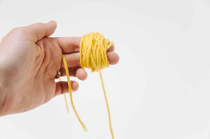 How to Make Yarn Pom Poms By Hand, Without a Pom Pom Maker