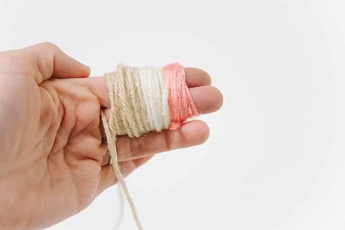 wrap three colors of yarn to make pom pom