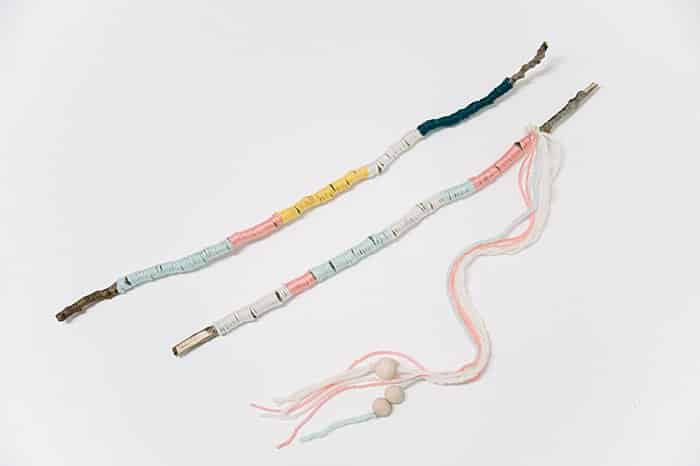 add string and beads to make a diy nature wand from yarn wrapped sticks