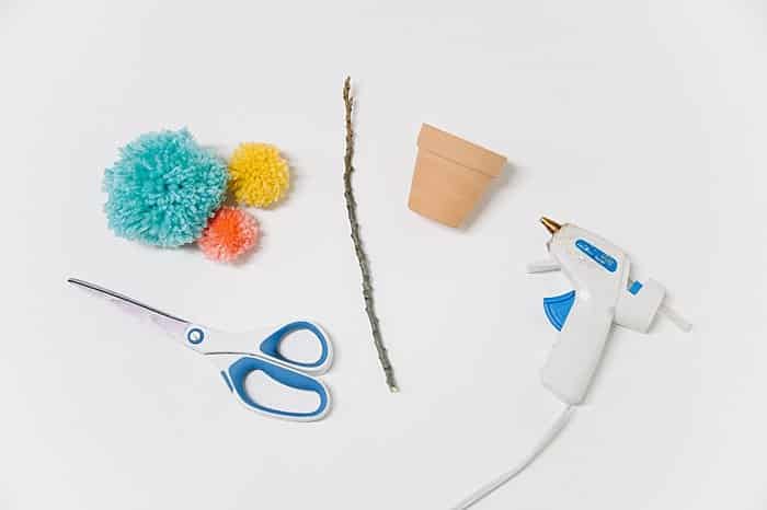 supplies to make a diy yarn pom pom flower