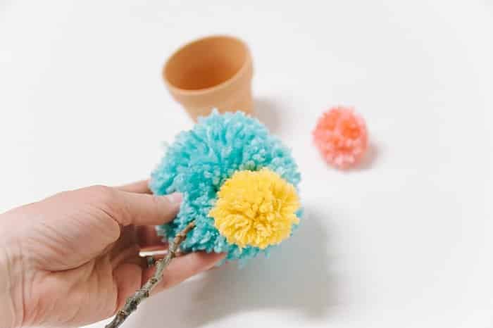 hot glue accent pom poms to large pom pom