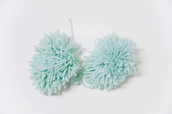 two large yarn pom poms to use to make potted cactus plant