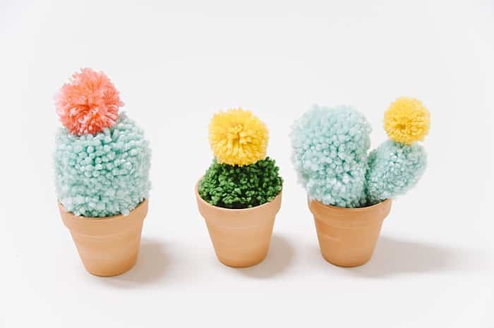 Potted faux cacti made with yarn.