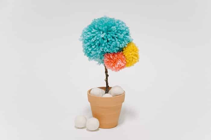 diy yarn pom pom flower in a mini clay pot