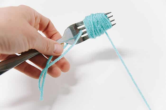 how to make a pom pom with a fork and yarn step by step with photos