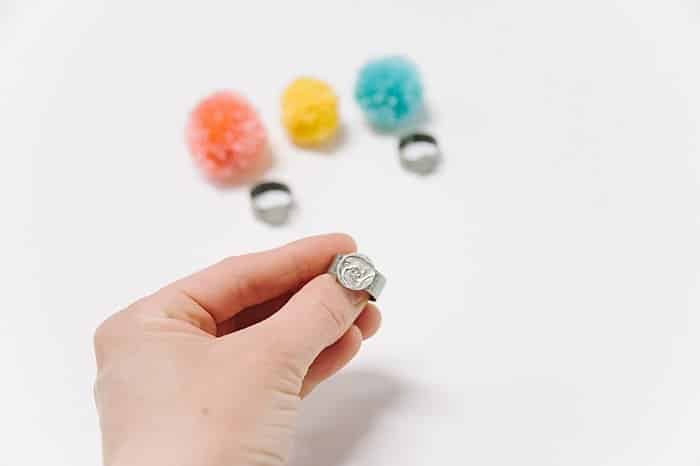 hot glue pompom onto ring blank to make a ring