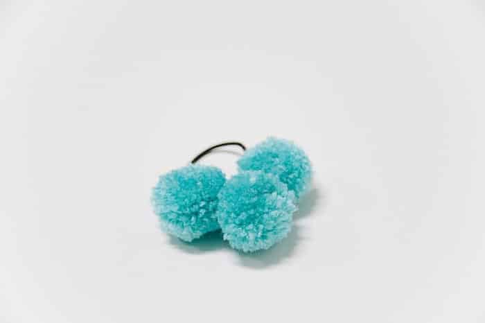 hair ties with pom poms on them