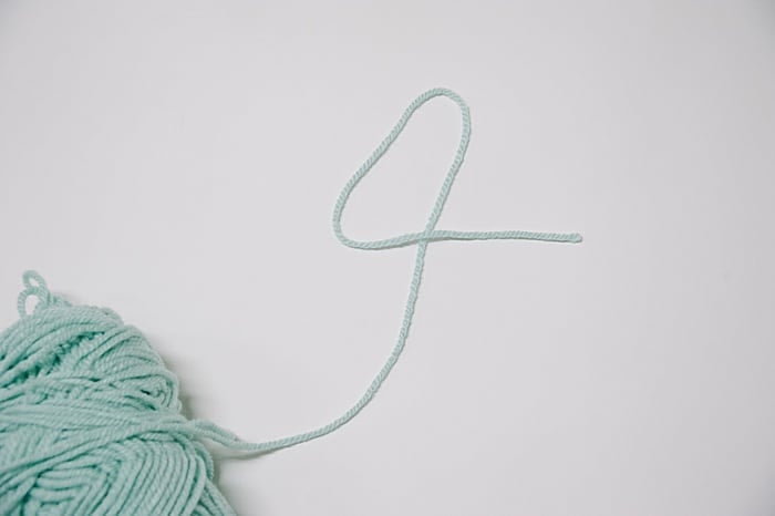 first step to make a slip knot, make a number four with the yarn