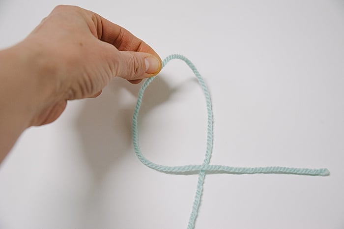 use your hand to grab the top of the yarn and pull it down to create a slip knot