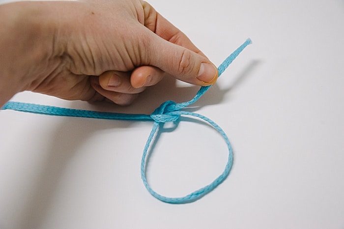 pull the end of your cording to tighten the sliding knot