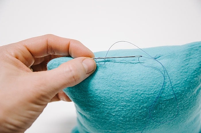 Pass needle through loop to make a small knot next to your blind stitches