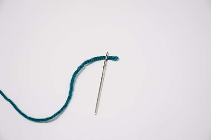 Pull the yarn through the eye of the needle, and you have successfully tied yarn onto your needle