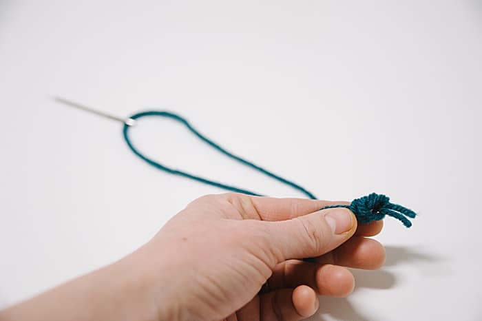 pull the knot tight to secure the end of your double thread strand