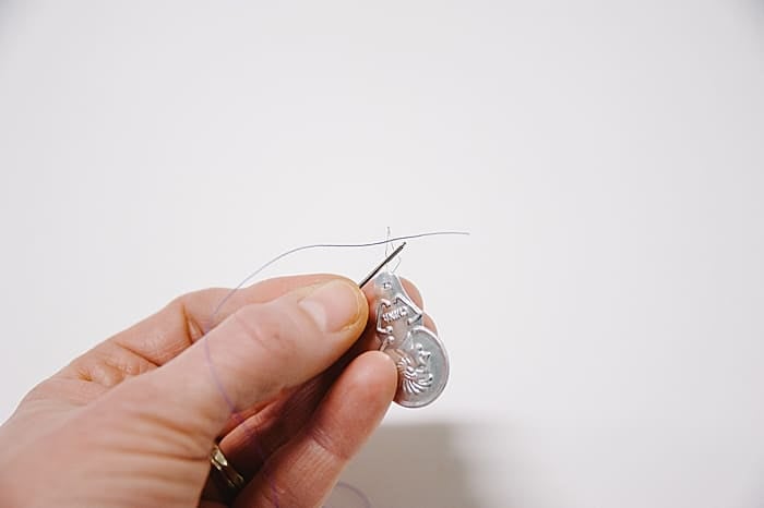 pass thread through the wire end of your needle threader