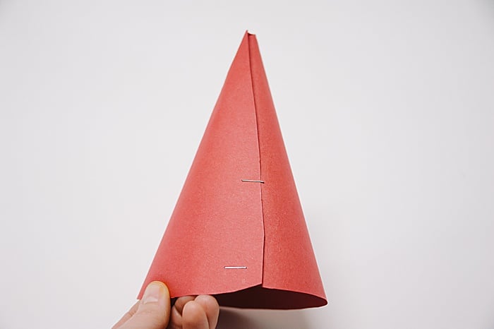 A cone made out of paper, secured with staples.