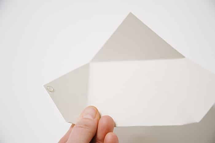 put a dab of hot glue on the left flap of the paper envelope to secure