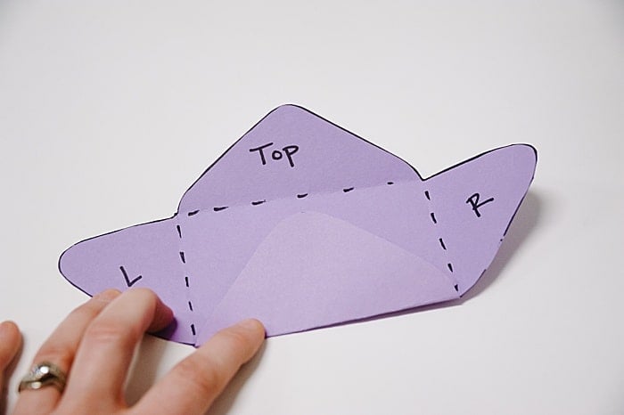 second option for folding up paper envelope, bottom folds up first and left and right wings come second.