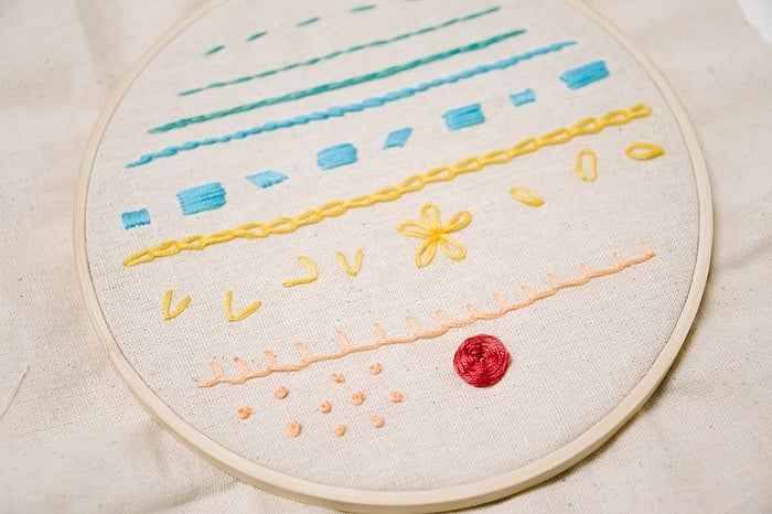 to make a woven wheel embroidery stitch, go over and under each stitch, repeat as the woven wheel rose embroidery stitch forms