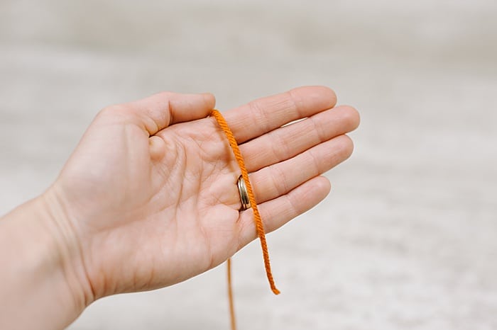 wrap yarn around your palm to make a tassel out of yarn