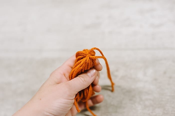 knot the yarn at the top of the diy tassel